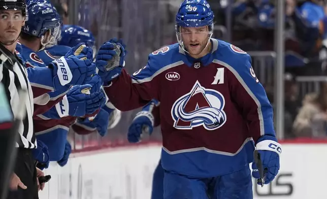 Colorado Avalanche right wing Mikko Rantanen celebrates a goal with teammates on the bench during the second period of an NHL hockey game against the Seattle Kraken Tuesday, Nov. 5, 2024, in Denver. (AP Photo/Jack Dempsey)