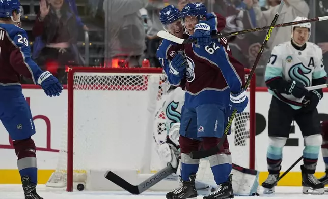 Colorado Avalanche left wing Artturi Lehkonen (62) is congratulated by teammate Casey Mittelstadt (37) after scoring a goal against the Seattle Kraken during the second period of an NHL hockey game Tuesday, Nov. 5, 2024, in Denver. (AP Photo/Jack Dempsey)