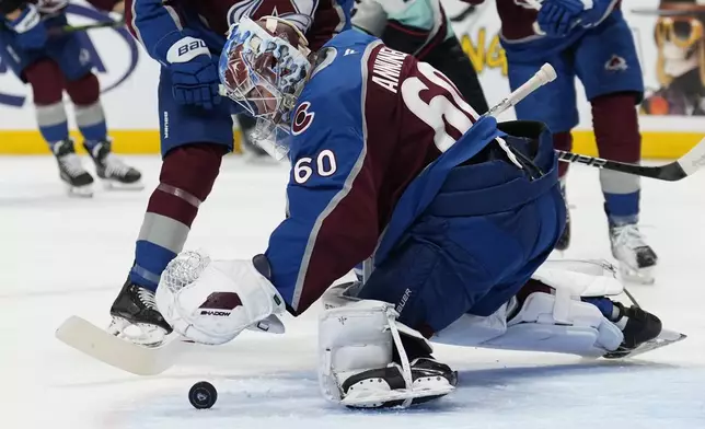 Colorado Avalanche goaltender Justus Annunen blocks a shot against the Seattle Kraken during the second period of an NHL hockey game Tuesday, Nov. 5, 2024, in Denver. (AP Photo/Jack Dempsey)