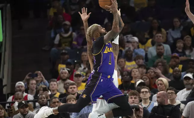 Los Angeles Lakers guard D'Angelo Russell (1) shoots defended by Memphis Grizzlies guard Ja Morant (12) in the first half of an NBA basketball game Wednesday, Nov. 6, 2024, in Memphis, Tenn. (AP Photo/Nikki Boertman)