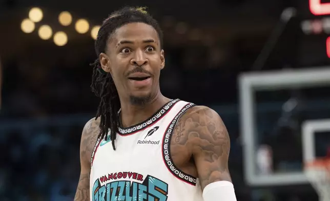 Memphis Grizzlies guard Ja Morant (12) reacts in the second half of an NBA basketball game against the Los Angeles Lakers Wednesday, Nov. 6, 2024, in Memphis, Tenn. (AP Photo/Nikki Boertman)