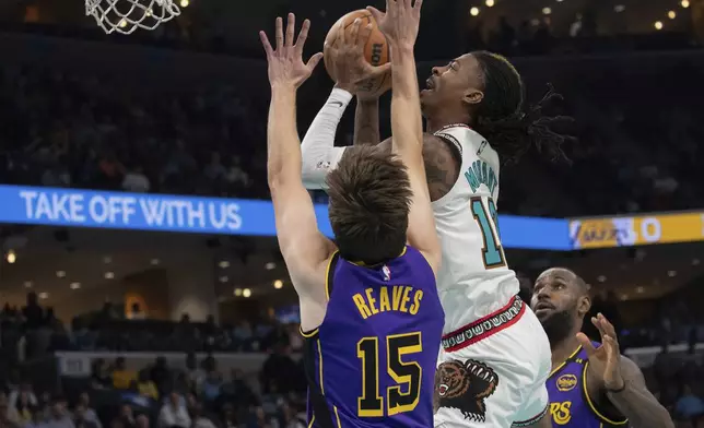 Memphis Grizzlies guard Ja Morant (12) shoots defended by Los Angeles Lakers guard Austin Reaves (15) and Los Angeles Lakers forward LeBron James, right, in the first half of an NBA basketball game Wednesday, Nov. 6, 2024, in Memphis, Tenn. (AP Photo/Nikki Boertman)