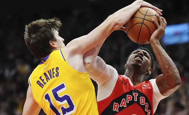 Los Angeles Lakers' Austin Reaves (15) fouls Toronto Raptors' RJ Barrett during the first half of an NBA basketball game in Toronto on Friday, Nov. 1, 2024. (Frank Gunn/The Canadian Press via AP)