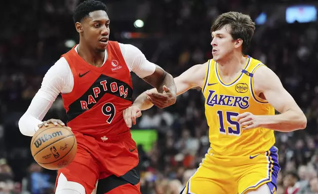 Toronto Raptors' RJ Barrett (9) drives past Los Angeles Lakers' Austin Reaves (15) during the first half of an NBA basketball game in Toronto on Friday, Nov. 1, 2024. (Frank Gunn/The Canadian Press via AP)