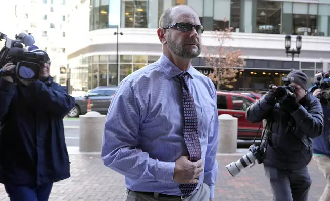 Jack Michael Teixeira, center, father of Massachusetts Air National Guardsman Jack Teixeira. arrives at federal court for his son's sentencing hearing, Tuesday, Nov. 12, 2024, in Boston,. (AP Photo/Steven Senne)