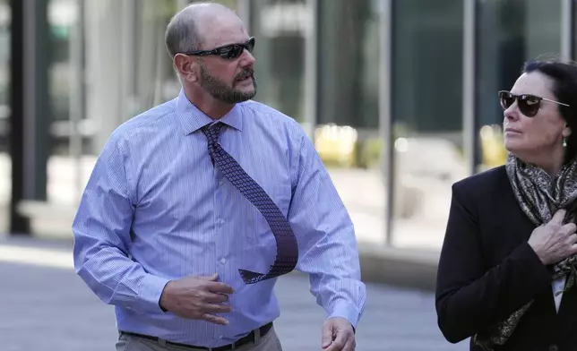 Jack Michael Teixeira, center, father of Massachusetts Air National Guardsman Jack Teixeira. arrives at federal court for his son's sentencing hearing, Tuesday, Nov. 12, 2024, in Boston,. (AP Photo/Steven Senne)