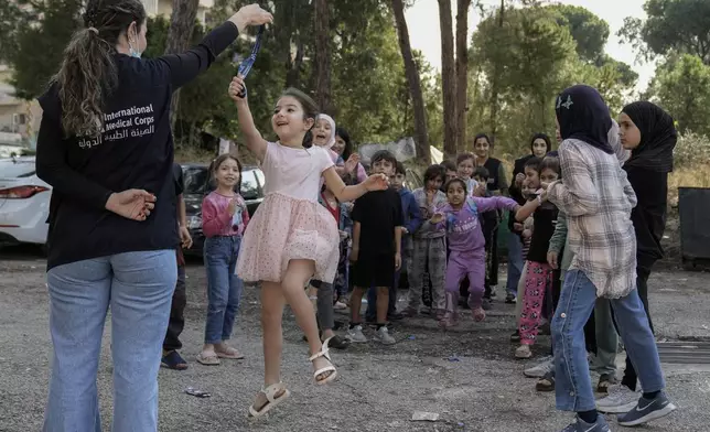 Displaced children take part in activities, organized by the International Medical Corps, at a shelter housing them in Dekwaneh, east Beirut, Lebanon, Thursday, Nov. 7, 2024. (AP Photo/Bilal Hussein)