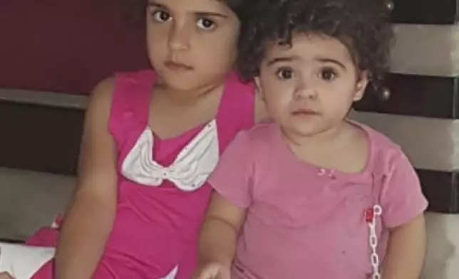 In this undated photo provided by Fatima Zayoun, Rahaf Skakye, 7, left, and her sister Ivana Skakye, 2, pose for photo earlier this year before both girls suffered severe burns in their home in southern Lebanon following an Israeli airstrike last September near their home in the village of Deir Qanoun al Nahr, south Lebanon. (Fatima Zayoun via AP)