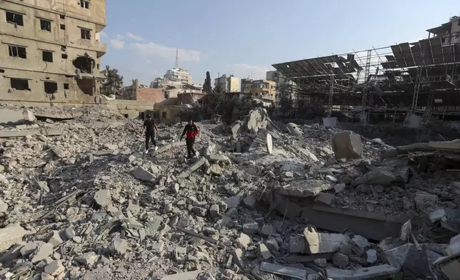 Resident check the site of an Israeli airstrike in Tyre, southern Lebanon, Saturday, Nov. 9, 2024. (AP Photo/Mohammad Zaatari)