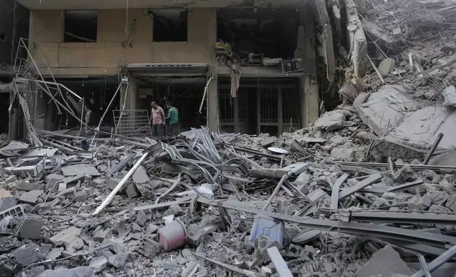 Residents check the site of an Israeli airstrike in Dahiyeh, Beirut, Lebanon , Saturday, Nov. 9, 2024. (AP Photo/Hassan Ammar)