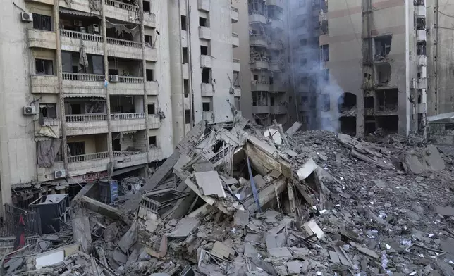 Smoke rises from a destroyed building that was hit by an Israeli airstrike on Dahiyeh, in the southern suburb of Beirut, Lebanon, Friday, Nov. 1, 2024. (AP Photo/Hussein Malla)