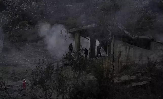 Rescue workers search for victims at a house hit in an Israeli airstrike in Baalchmay village east of Beirut, Lebanon, Tuesday, Nov. 12, 2024. (AP Photo/Hassan Ammar)