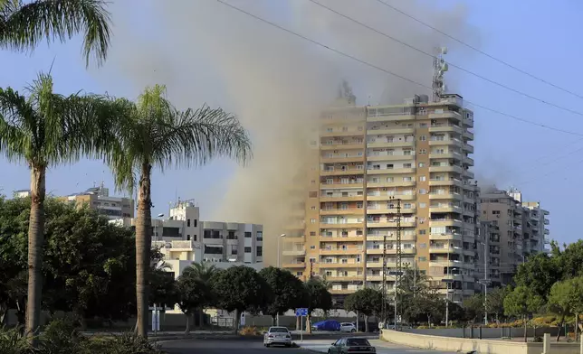 Smoke rises from buildings hit in Israeli airstrikes in Tyre, southern Lebanon, Thursday, Nov. 7, 2024. (AP Photo/Mohammed Zaatari)