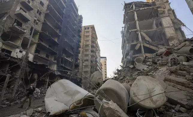 A resident checks the site of an Israeli airstrike in Dahiyeh, Beirut, Lebanon, Saturday, Nov. 9, 2024. (AP Photo/Hassan Ammar)