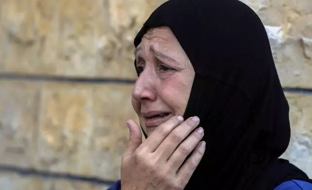 A woman mourns during the funeral procession of people who were killed in an Israeli airstrike on Tuesday night, in Tyre, southern Lebanon, Thursday, Nov. 7, 2024. (AP Photo/Mohammed Zaatari)