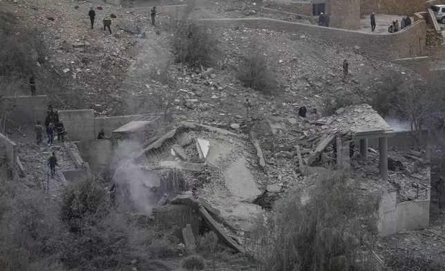 Rescue workers search for victims at a house hit in an Israeli airstrike in Baalchmay village east of Beirut, Lebanon, Tuesday, Nov. 12, 2024. (AP Photo/Hassan Ammar)