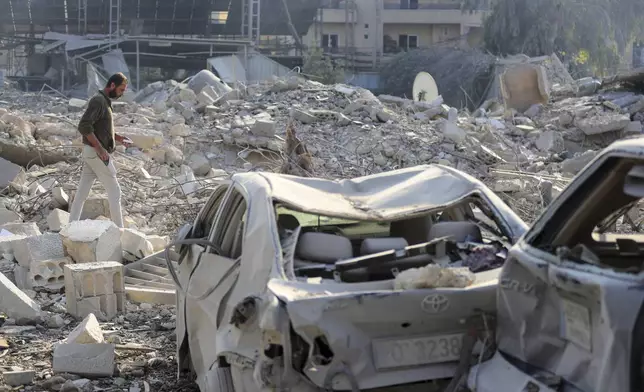 A resident checks the site of an Israeli airstrike in Tyre, southern Lebanon, Saturday, Nov. 9, 2024. (AP Photo/Mohammad Zaatari)