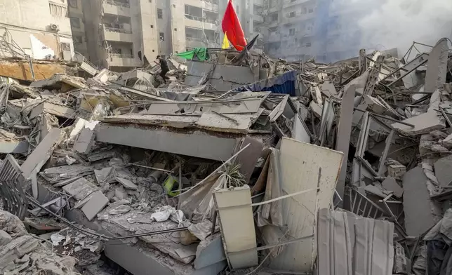 A man walks on the rubble of his destroyed apartment following an Israeli airstrike in Dahiyeh, Beirut, Lebanon, Friday, Nov. 1, 2024. (AP Photo/Hassan Ammar)