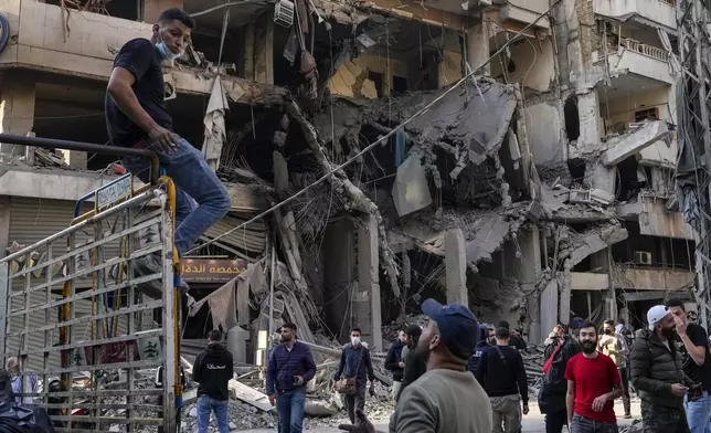 Residents check the site of an Israeli airstrike in Dahiyeh, Beirut, Lebanon, Saturday, Nov. 9, 2024. (AP Photo/Hassan Ammar)