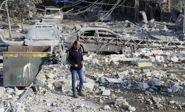 A resident checks the site of an Israeli airstrike in Tyre, southern Lebanon, Saturday, Nov. 9, 2024. (AP Photo/Mohammad Zaatari)