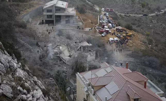 Rescue workers search for victims at a house hit in an Israeli airstrike in Baalchmay village east of Beirut, Lebanon, Tuesday, Nov. 12, 2024. (AP Photo/Hassan Ammar)