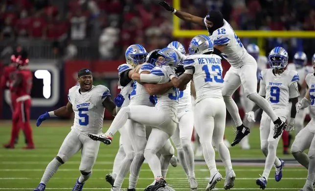 Detroit Lions kicker Jake Bates, center, celebrates with teammates after kicking the game-winning field goal against the Houston Texans during the fourth quarter of an NFL football game Sunday, Nov. 10, 2024, in Houston. (AP Photo/David J. Phillip)