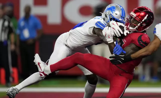 Houston Texans wide receiver John Metchie III catches a 15-yard touchdown pass in front of Detroit Lions cornerback Terrion Arnold, left, during the first half of an NFL football game, Sunday, Nov. 10, 2024, in Houston. (AP Photo/David J. Phillip)