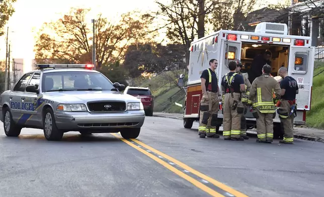 Members of the Louisville Fire Departments check their gear as they prepare to enter Givaudan Sense Colour following an explosion at the facility in Louisville, Ky., Tuesday, Nov. 12, 2024. (AP Photo/Timothy D. Easley)