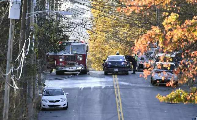 Members of the Louisville Metro Police and Louisville Fire Departments block access to Givaudan Sense Colour following an explosion at the facility in Louisville, Ky., Tuesday, Nov. 12, 2024. (AP Photo/Timothy D. Easley)