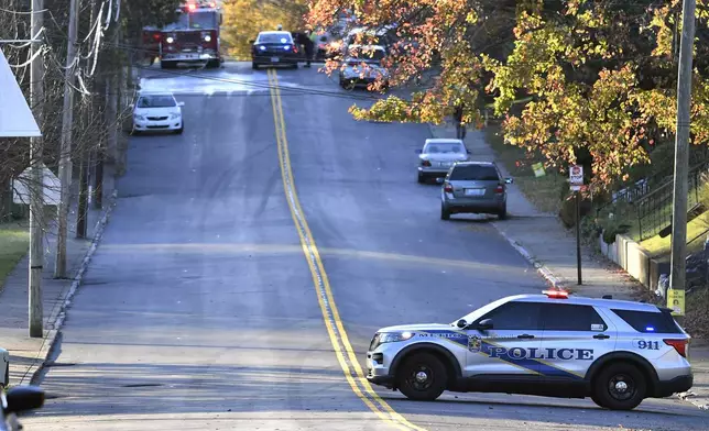 Members of the Louisville Metro Police and Louisville Fire Departments block access to Givaudan Sense Colour following an explosion at the facility in Louisville, Ky., Tuesday, Nov. 12, 2024. (AP Photo/Timothy D. Easley)