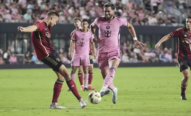 Atlanta United defender Stian Gregersen (5) and Inter Miami forward Leonardo Campana (8) go after the ball during the second half of their MLS playoff opening round soccer match, Saturday, Nov. 9, 2024, in Fort Lauderdale, Fla. (AP Photo/Lynne Sladky)