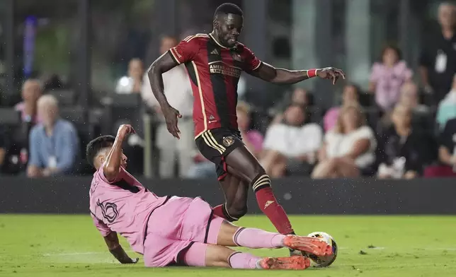 Inter Miami midfielder Tomás Aviles (6) blocks a pass by Atlanta United forward Jamal Thiaré (29) during the second half of their MLS playoff opening round soccer match, Saturday, Nov. 9, 2024, in Fort Lauderdale, Fla. (AP Photo/Rebecca Blackwell)