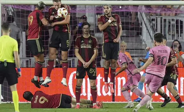 Atlanta United defender Stian Gregersen (5) blocks a kick by Inter Miami forward Lionel Messi (10) during the second half of their MLS playoff opening round soccer match, Saturday, Nov. 9, 2024, in Fort Lauderdale, Fla. (AP Photo/Rebecca Blackwell)