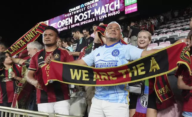 Atlanta United fans celebrate at the end of their MLS playoff opening round soccer match against Inter Miami, Saturday, Nov. 9, 2024, in Fort Lauderdale, Fla. (AP Photo/Lynne Sladky)