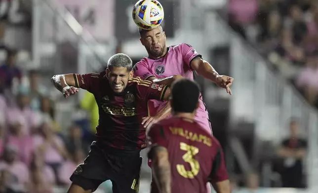 Atlanta United defender Luis Abram (4) and Inter Miami defender Marcelo Weigandt (57) go after the ball during the first half of an MLS playoff opening round soccer match, Saturday, Nov. 9, 2024, in Fort Lauderdale, Fla. (AP Photo/Rebecca Blackwell)