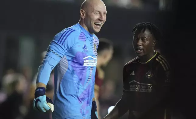 Atlanta United goalkeeper Brad Guzan (1) celebrates after defeating Inter Miami during an MLS playoff opening round soccer match, Saturday, Nov. 9, 2024, in Fort Lauderdale, Fla. (AP Photo/Lynne Sladky)