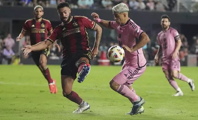 Atlanta United defender Derrick Williams (3) passes the ball as Inter Miami forward Luis Su·rez (9) defends during the second half of their MLS playoff opening round soccer match, Saturday, Nov. 9, 2024, in Fort Lauderdale, Fla. (AP Photo/Lynne Sladky)