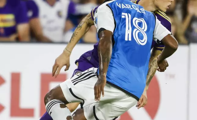 Orlando City midfielder Dagur Dan Þórhallsson, right, changes direction with the ball against Charlotte FC forward Kerwin Vargas (18) during the first half of Game 3 of a first round MLS Cup playoff soccer match Saturday, Nov. 9, 2024, in Orlando, Fla. (AP Photo/Kevin Kolczynski)