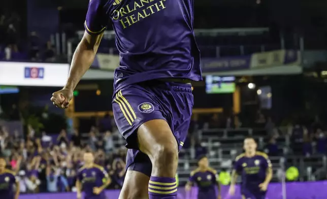 Orlando City defender Rafael Santos celebrates after scoring the winning shoot-out kick against Charlotte FC after the end of regulation play of Game 3 in the first round MLS Cup playoff soccer match Saturday, Nov. 9, 2024, in Orlando, Fla. (AP Photo/Kevin Kolczynski)