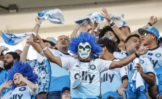 Charlotte FC fans celebrate prior to Game 3 of a first round MLS Cup playoff soccer match against Orlando City Saturday, Nov. 9, 2024, in Orlando, Fla. (AP Photo/Kevin Kolczynski)