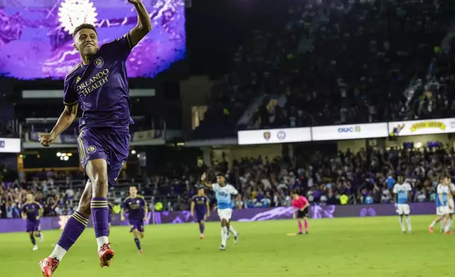 Orlando City defender Rafael Santos celebrates after scoring the winning shoot-out kick against Charlotte FC after the end of regulation play of Game 3 in the first round MLS Cup playoff soccer match Saturday, Nov. 9, 2024, in Orlando, Fla. (AP Photo/Kevin Kolczynski)