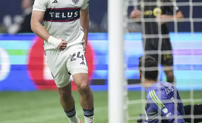 Vancouver Whitecaps' Brian White (24) celebrates after his goal against Los Angeles FC goalkeeper Hugo Lloris, front right, during the second half of Game 2 in the first round of the MLS Cup soccer playoffs in Vancouver, British Columbia, Sunday, Nov. 3, 2024. (Darryl Dyck/The Canadian Press via AP)