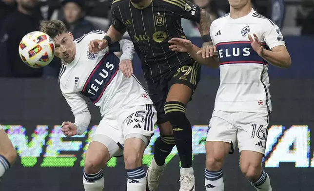 Los Angeles FC's Denis Bouanga, center, vies for the ball against Vancouver Whitecaps' Ryan Gauld, left, and Sebastian Berhalter, right, during the first half of Game 2 in the first round of the MLS Cup soccer playoffs in Vancouver, British Columbia, Sunday, Nov. 3, 2024. (Darryl Dyck/The Canadian Press via AP)