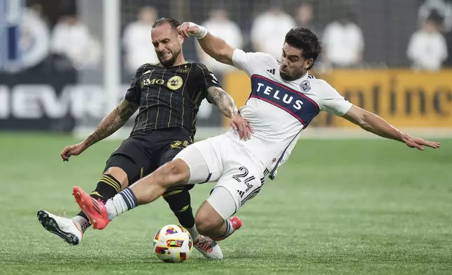 Los Angeles FC's Maxime Chanot, left, and Vancouver Whitecaps' Brian White, right, vie for the ball during the first half of Game 2 in the first round of the MLS Cup soccer playoffs in Vancouver, British Columbia, Sunday, Nov. 3, 2024. (Darryl Dyck/The Canadian Press via AP)