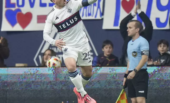 Vancouver Whitecaps' Ryan Gauld, left, celebrates after his goal against Los Angeles FC during the first half of Game 2 in the first round of the MLS Cup soccer playoffs in Vancouver, British Columbia, Sunday, Nov. 3, 2024. (Darryl Dyck/The Canadian Press via AP)