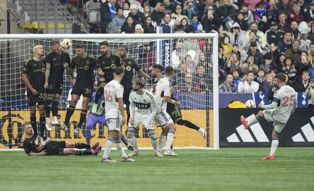 Vancouver Whitecaps' Ryan Gauld, front right, takes a free kick as, from top left to right, Los Angeles FC's Aaron Long, Maxime Chanot, Ryan Hollingshead, Olivier Giroud, Timothy Tillman, Denis Bouanga and Lewis O'Brien, bottom left, defend during the first half of Game 2 in the first round of the MLS Cup soccer playoffs in Vancouver, British Columbia, Sunday, Nov. 3, 2024. (Darryl Dyck/The Canadian Press via AP)