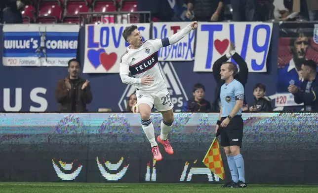 Vancouver Whitecaps' Ryan Gauld, left, celebrates after his goal against Los Angeles FC during the first half of Game 2 in the first round of the MLS Cup soccer playoffs in Vancouver, British Columbia, Sunday, Nov. 3, 2024. (Darryl Dyck/The Canadian Press via AP)