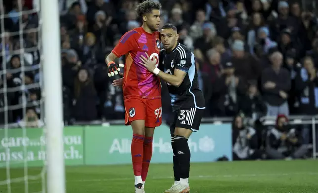 Minnesota United goalkeeper Francesco Montali (98) and midfielder Hassani Dotson (31) react after Dotson scored during a penalty shoot out in a first-round soccer match of the MLS Cup playoffs against the Real Salt Lake in St. Paul, Minn., Saturday, Nov. 2, 2024. (AP Photo/Ellen Schmidt)