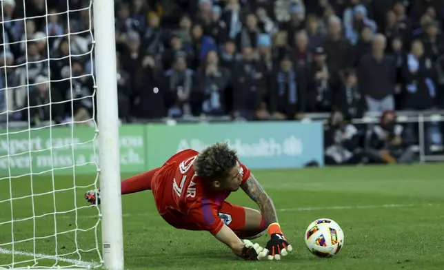 Minnesota United goalkeeper Dayne St. Clair saves the ball on a Real Salt Lake penalty kick during a first-round soccer match of the MLS Cup playoffs in St. Paul, Minn., Saturday, Nov. 2, 2024. (AP Photo/Ellen Schmidt)