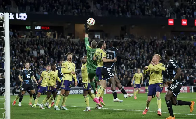 Real Salt Lake goalkeeper Zac MacMath (18) saves the ball after a Minnesota United corner kick during the first half of a first-round soccer match of the MLS Cup playoffs in St. Paul, Minn., Saturday, Nov. 2, 2024. (AP Photo/Ellen Schmidt)